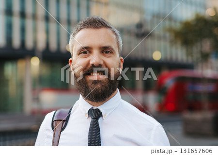 Smiling businessman on the street in the city. 131657606