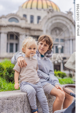 Two young boy tourists in front of Palacio de Bellas Artes in Mexico City, enjoying sightseeing, travel adventure, and cultural exploration. Childhood travel and tourism concept Two young boy tourists in front of Palacio de Bellas Artes in Mexico City, enjoying sightseeing, travel adventure, and cultural exploration. Childhood travel and tourism concept 131657988