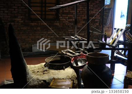 Separate silk worm via spinning wheel, Thai wisdom. process highlights sustainable textile making, natural materials, and the dedication in rural workshops. 131658150