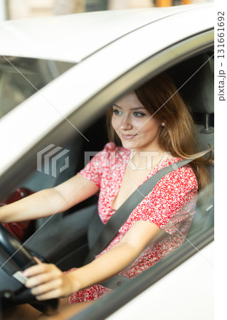 Woman driving in car, buckled up Woman driving in car, buckled up 131661692