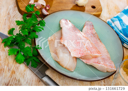 Raw rockfish fillet with condiments, cooking ingredients Raw rockfish fillet with condiments, cooking ingredients 131661729