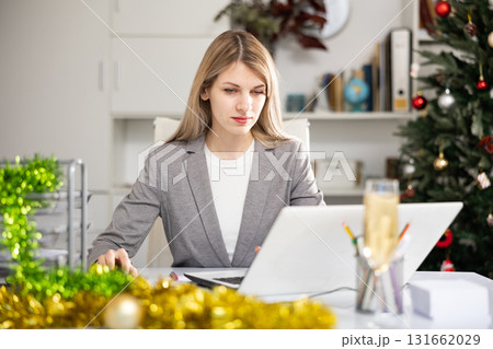 Office manager works with documents and laptop during christmas 131662029