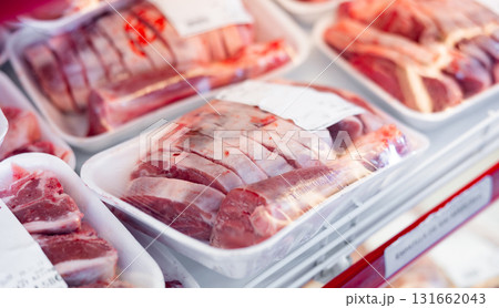 Packaged pork meat laid out on display shelves of butcher store Packaged pork meat laid out on display shelves of butcher store 131662043