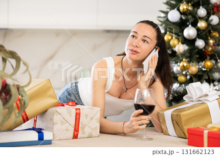 woman is relaxing at home with glass of wine during New Year holidays 131662123