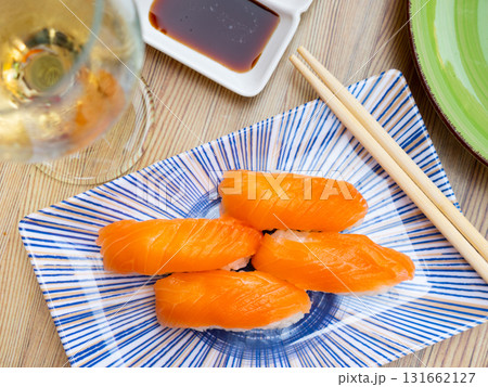 Sake nigiri - dietary sushi with salmon and tuna, soy sauce closeup 131662127