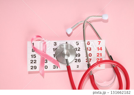 Calendar featuring marked dates with pink ribbon and stethoscope Calendar featuring marked dates with pink ribbon and stethoscope 131662182