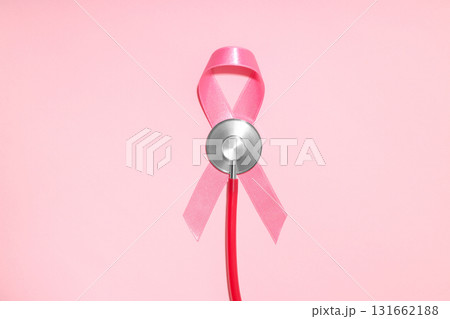 Pink ribbon attached to a stethoscope on pink background 131662188