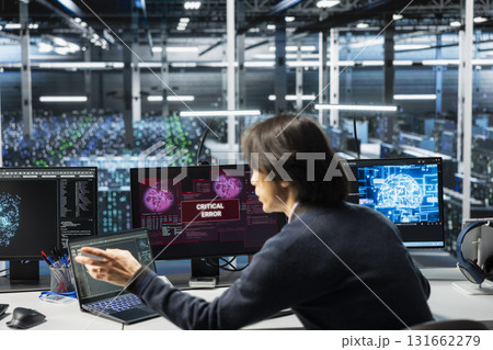 Data center software developer struggling to fix malfunctions while using AI tools. Server farm IT expert receiving critical error while using artificial intelligence to optimize system health 131662279