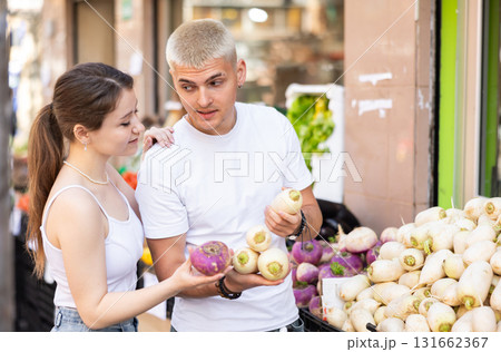 couple choose turnips on the market couple choose turnips on the market 131662367