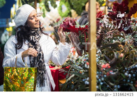 Confident Latin American woman chooses a composition of flowers Confident Latin American woman chooses a composition of flowers 131662415