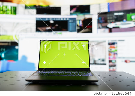 Close up of green screen laptop and VOD entertainment channels video collage. Chroma key notebook in front of virtual background displaying social network feed activity digital dashboard 131662544