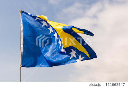 Flag of Bosnia and Herzegovina flying against blue sky 131662547