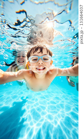 Portrait of a boy swimming underwater in a pool. A joyful child looks at the camera. 131664037