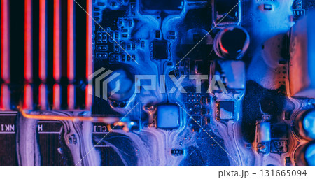 Ink drip. Mainboard chip. Defocused blue purple orange color electronic board water on abstract acrylic light digital art background. 131665094