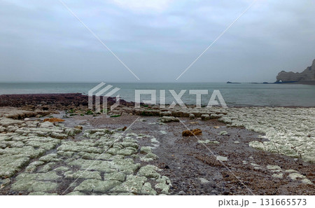 A serene coastal landscape with a rugged shoreline and calm waters, ideal for relaxation A serene coastal landscape with a rugged shoreline and calm waters, ideal for relaxation 131665573