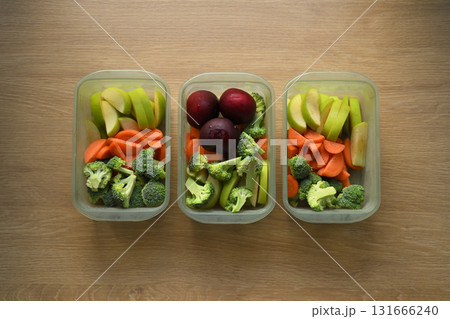 Flat lay of healthy weekly meal prep in plastic containers on wooden kitchen counter Flat lay of healthy weekly meal prep in plastic containers on wooden kitchen counter 131666240