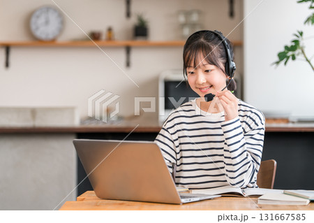 リビングでパソコンでインカム,ヘッドセットをつけて勉強を受する小学生・中学生・高校生 131667585