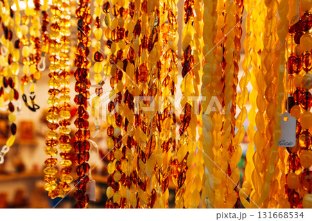 Amber Beads in a Street Shop. Orange Baltic Sea Souvenir, Natural Jewelry, Gold Brown Stone Necklace Amber Beads in a Street Shop. Orange Baltic Sea Souvenir, Natural Jewelry, Gold Brown Stone Necklace 131668534