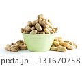 A light green bowl overflowing with roasted peanuts in the shell, isolated on a clean white background. Healthy snack or ingredient. 131670758