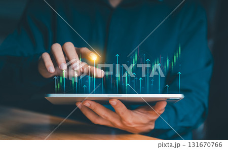 Hand holding a tablet from which a glowing upward trend graph emerges. Concept of business growth, financial success, and market achievement. 131670766