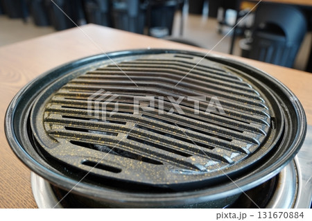 Korean Barbecue Charcoal Grill Plate in Restaurant Korean Barbecue Charcoal Grill Plate in Restaurant 131670884