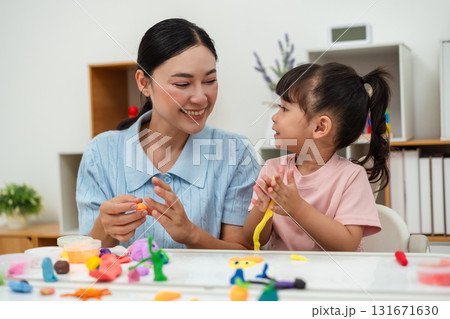 toddler girl with mother sculpting from plasticine at home toddler girl with mother sculpting from plasticine at home 131671630