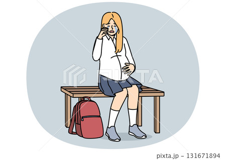 Pregnant schoolgirl is crying, sitting on bench and experiencing stress due to early motherhood 131671894