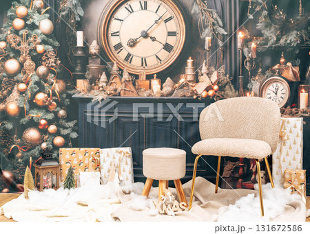 Beautiful Christmas scene with soft chair, wrapped presents, and glowing tree lights. Elegant festive home decoration Beautiful Christmas scene with soft chair, wrapped presents, and glowing tree lights. Elegant festive home decoration 131672586