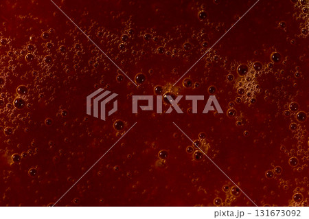 Red liquid texture with bubbles, abstract macro background Red liquid texture with bubbles, abstract macro background 131673092