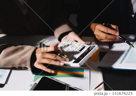 Business Team Analyzing Financial Data in Modern Office Business Team Analyzing Financial Data in Modern Office 131674225