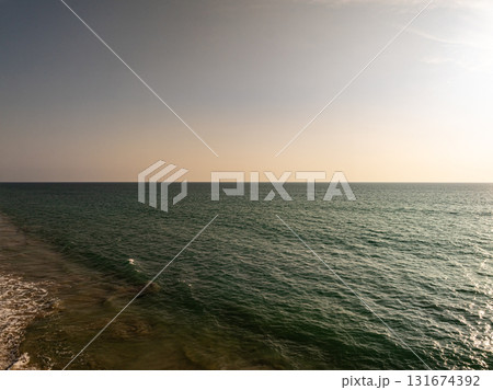 Beautiful sky sunset or sunrise clouds over sea nature background Beautiful sky sunset or sunrise clouds over sea nature background 131674392