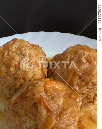 Meatballs with rice and onions simmered in tomato sauce. Delicious and healthy home cooking. Meatballs with rice and onions simmered in tomato sauce. Delicious and healthy home cooking. 131675043
