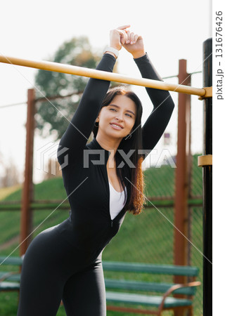Woman Hanging On Fitness Equipment Bar Woman Hanging On Fitness Equipment Bar 131676426