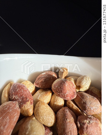 Closeup of roasted salted peanuts. 131677458