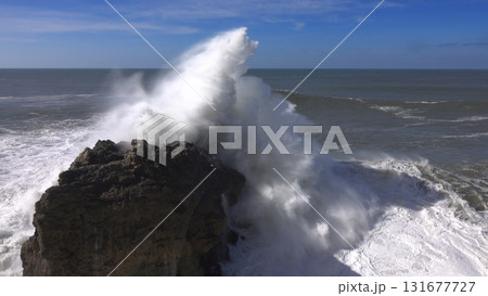 High waves breaking on the rocks of the coastline High waves breaking on the rocks of the coastline 131677727