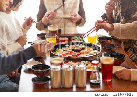 実家へ帰省した家族とおばあちゃんで囲む正月の食卓 131677926