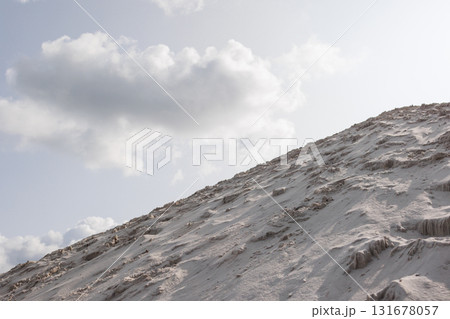 Scenic view of sandy hill under cloudy sky 131678057