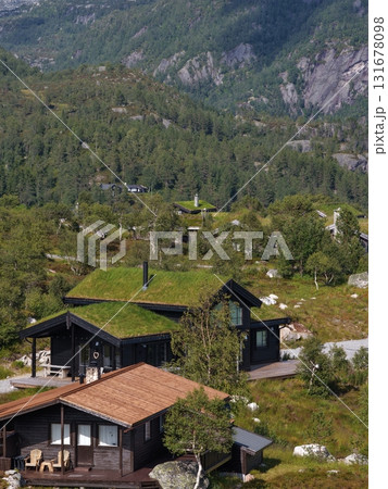 Traditional norwegian cabins with green sod roofs in mountains Traditional norwegian cabins with green sod roofs in mountains 131678098
