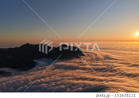 Sunrise glowing above mountain peaks and a sea of clouds, Switzerland 131678111