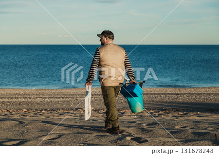 Fisherman Arriving At The Beach To Fish Fisherman Arriving At The Beach To Fish 131678248