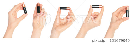 Set of human hands holding battery isolated on transparent background Set of human hands holding battery isolated on transparent background 131679049