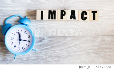 IMPACT ,a word on wooden blocks on a gray background 131679288