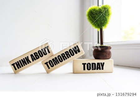 Think about tomorrow today, text on wooden blocks on a beautiful background, business concept Think about tomorrow today, text on wooden blocks on a beautiful background, business concept 131679294