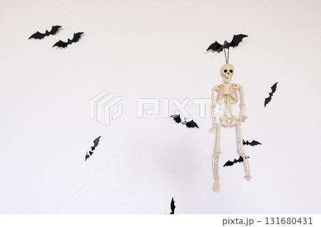 Halloween skeleton and bats decoration on white wall Halloween skeleton and bats decoration on white wall 131680431