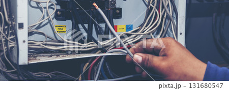 Banner Electrical mechanic technician check wire electric cabinet. Inspector men hands working maintenance service. Electrician circuit repair operation. Men hands fix breaker with copy space 131680547