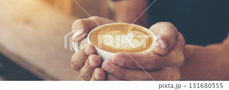 Banner Coffee barista pour espresso shot and make latte art hot coffee cup. Cappuccino with milk in italian coffee shop cafe. Banner Close up hands of barista make brown latte art with copy space Banner Coffee barista pour espresso shot and make latte art hot coffee cup. Cappuccino with milk in italian coffee shop cafe. Banner Close up hands of barista make brown latte art with copy space 131680555