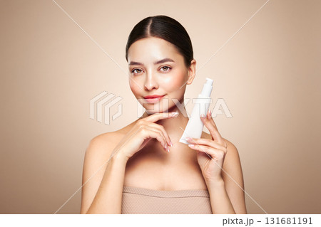 Beautiful woman with bottle of moisturizer cream 131681191