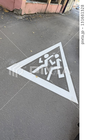 Pedestrian crossing sign painted on urban street pavement conveying safety message Pedestrian crossing sign painted on urban street pavement conveying safety message 131681328