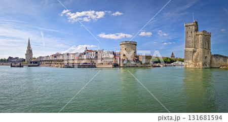 Panoramic view of the iconic entrance to the Vieux Port of La Rochelle, France. Panorama of all three medieval towers guarding the marina, the Tour Saint-Nicolas near the chain and the lantern towers 131681594