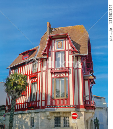 La Rochelle, France - May 08, 2024: The famous Maison du Chat (Cat Mansion), vibrant red and white Neo-Norman half-timbered architecture house. Distinctive historic building as city landmark 131681595
